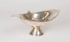 A silver elliptical dish. 9cm high, 27.5cm wide.