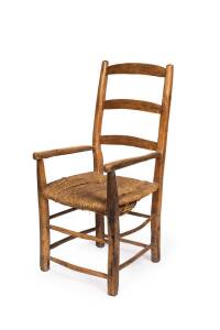 A rustic antique French provincial fruitwood armchair.