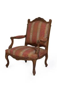 An antique French airchair with carved walnut frame, early 19th century. 