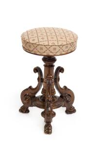 A Victorian carved walnut revolving piano stool. 55cm high