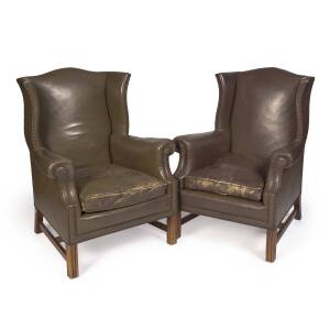 A pair of leather wingback armchairs, early 20th century. 