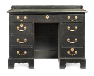 An ebonized kneehole desk with brass handles and leather top, English, 19th century.71cm high, 95cm wide, 46cm deep
