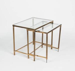 A nest of two brass and silvered glass top occasional tables, French, circa 1940.