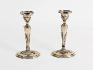 A pair of George V sterling silver oval fluted candlesticks by William Hutton and Sons Ltd. 19cm high  