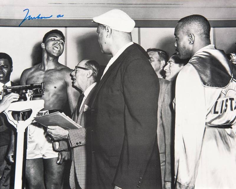 MUHAMMAD ALI, signed b/w photograph of Ali at weigh-in with Sonny Liston, size 51x41cm.