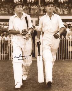 DON BRADMAN, signature on photograph of Don Bradman & Jack Fingleton walking out to bat in a 1935 Test match, window mounted, framed & glazed, overall 31x37cm. With CoA.