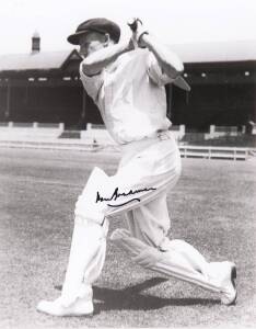 DON BRADMAN, signed photograph of the Don playing a cover drive, window mounted, framed & glazed, overall 34x42cm. With CoA.