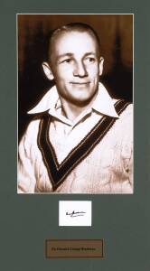 DON BRADMAN, attractive display comprising large photograph of Bradman, window mounted with signature on card, nicely framed & glazed, overall 56x86cm. With CoA.