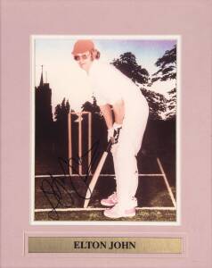 ELTON JOHN, signed photograph of Elton John in his cricket gear, window mounted, framed & glazed, overall 34x40cm.