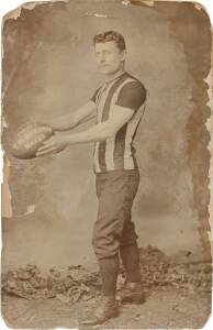 BILL STRICKLAND (after 8 seasons with Carlton in the VFA, he transferred & became Collingwood's first ever captain in the VFL): Original advertising photograph showing Bill Strickland in Collingwood gear, and with football marked "T.W.SHERRIN MAKER" & "C'