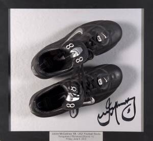 JASON McCARTNEY (Collingwood/ Adelaide/ North Melbourne/ Bali bombing survivor): Display with pair of "Nike - 88" football boots (88 representing the number of Australians who died in the Bali bombing), mounted on signed board with caption "Jason McCartne