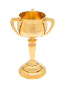 1949 MELBOURNE CUP, 3-handled loving cup, engraved on front "MELBOURNE CUP/ 1949. Won by Mr. L.G. Robinson's/ Foxzami", on wooden stand, 37cm tall.{Foxzami owned by Leonard G.Robinson won the 1949 Melbourne Cup by 3 lengths from Hoyle & Benvolo, before a 