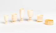 Five whale tooth and bone cups and a napkin ring ♦