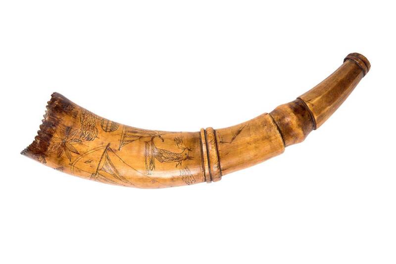 A scrimshaw powder horn engraved with kangaroo