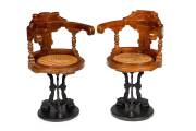 Two ornate revolving ships chairs on cast iron bases