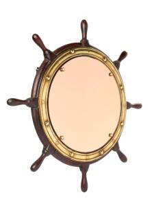 A ships wheel mirror with pink glass