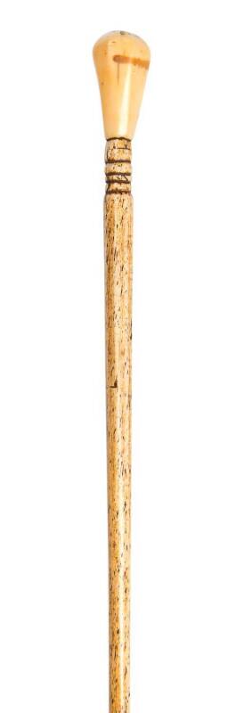 A whalebone walking stick with whale's tooth and pearl shell handle ♦