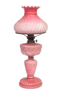 A ruby satin glass oil lamp with original shade, 19th C.