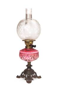 A ruby glass kerosene lamp with black button double burner and original acid etched shade