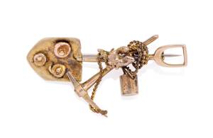 A miner's brooch, crossed pick and shovel, bucket and gold nuggets. Yellow gold. Weight 6.20 grams. Length 53mm.