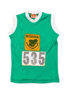 NIGERIAN RUNNING SINGLET, with Nigerian badge & numbers "535" on front and reverse, faded name inside collar. [Jack Ryder's notes state "Nigerian Women won gold medal"].