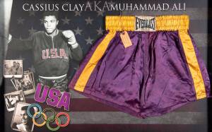 MUHAMMAD ALI: Training trunks used by former Olympic and world heavyweight champion Cassius Clay while working out at the Columbia Street Gym in Loisville, Kentucky under the authority of trainer Joe Martin.Purple "Everlast" trunks with gold waistband and