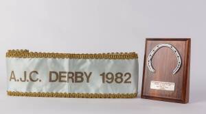 ROSE OF KINGSTON: Trophy with horseshoe mounted on wooden stand with plaque "VRC Australia's Champion Race Horse 1982, Rose of Kingston, Presented to R.E.Hoysted, Trainer, 28th October 1982"; plus winner's sash "AJC Derby 1982". Ex Bob Hoysted collection.