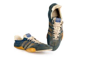 DICK QUAX'S RUNNING SHOES, one endorsed "Dick Quax, Worn 14-2-72, 4 x 1 Mile World Record 3:57.5, 1972". [Dick Quax won the silver medal in 5000m at 1976 Montreal Olympics, and in 1977 set a world record of 13:12.9 in the 5000m].