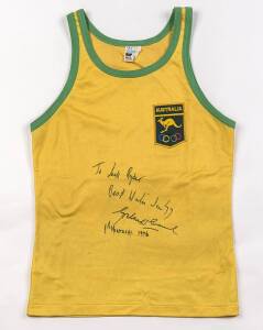 GRAHAM WINDEATT'S AUSTRALIAN SINGLET, green & gold with embroidered "Australia/ (kangaroo)/ (Olympic rings)" badge, endorsed on front "To Jack Ryder, Best wishes Ja '77, Graham Windeatt, 8th Montreal 1976". [Graham Windeatt won a silver medal in 1500m Fre