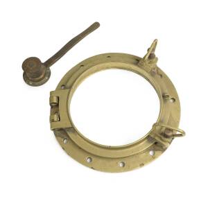 A solid brass ship's porthole and yacht's brass handle