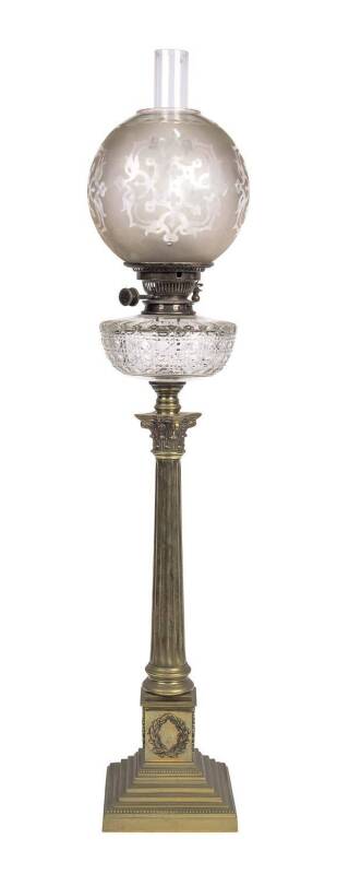 A Victorian oil lamp with acid etched shade