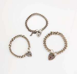 Three bracelets, of curblink design, hung with a heart shaped padlock. Silver.