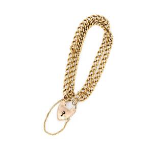 A gold bracelet, of double strand curblink design.18ct yellow gold. 9ct rose gold heart-shaped padlock. Total weight 29.1 grams. Length 18cm.