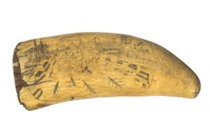 A scrimshaw whales tooth with London scene showing Putney Bridge and boat race, circa 1830's 