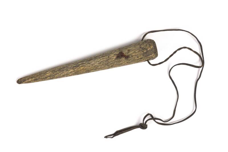 A whalebone fid on leather thong, 19th century