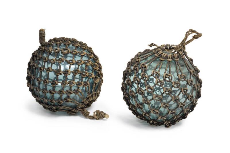 A pair of glass and rope buoys, early 20th century