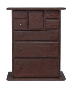 A miniature chest of drawers, remains of shop labels on drawer fronts, signed and dated "PERCY PRENTICE 1910", red pine with old crackle finish39cm high, 32cm wide, 15cm deep