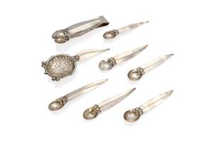 An Australian Arts and Crafts sterling silver designed tea strainer, sugar tongs and set of six tea spoons, circa 1900