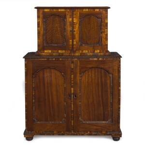 An early Colonial cabinet in two sections, cedar with tulipwood cross banding and pine stringing, most likely Tasmanian origin, circa 1825