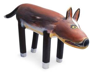 A carved wooden sculpture of a native dog (Aurakun)