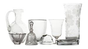 A collection of glassware including two etched vases, a dinner bell, two vases, two bowls and two paperweights