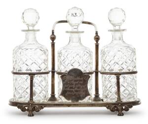 A German silver decanter stand and three cut glass decanters