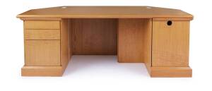 A blondewood shaped office desk