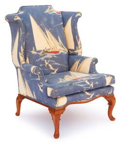 A Georgian style wingback arm chair, 20th century upholstered in sailing upholstery