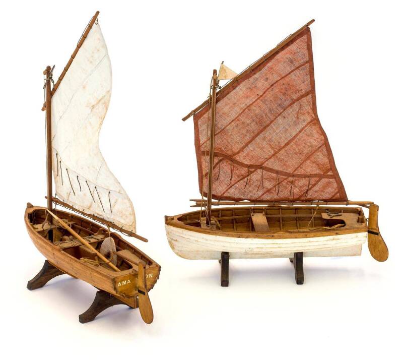 "SWALLOW" & "AMAZON", pair of sailing dinghies, clinker built plank on frame, drop keel, luff sail, twin thwarts, oars & rowlocks, running and fixed rigging; rudders fitted with gudgeons and pintles. each about 20cm long. [From the classic children's book