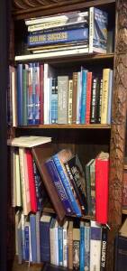 A collection of assorted books relating to sailing, fiction and other subjects