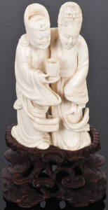 Japanese ivory figure group of a man & woman in each others arms supported on a carved wooden base in the form of clouds, early 20th century. 10cm, Excellent condition