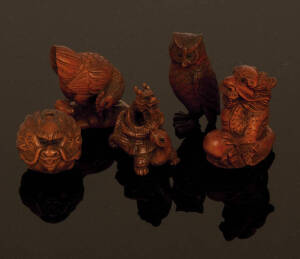NETSUKE: Collection of Japanese boxwood carvings; dragons (9); face masks (6); horses (4); birds (10). 20th century, excellent condition