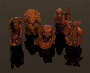 NETSUKE: Carved Japanese boxwood; figures (22); deer & buffalo (7); Skull. 20th century excellent condition.
