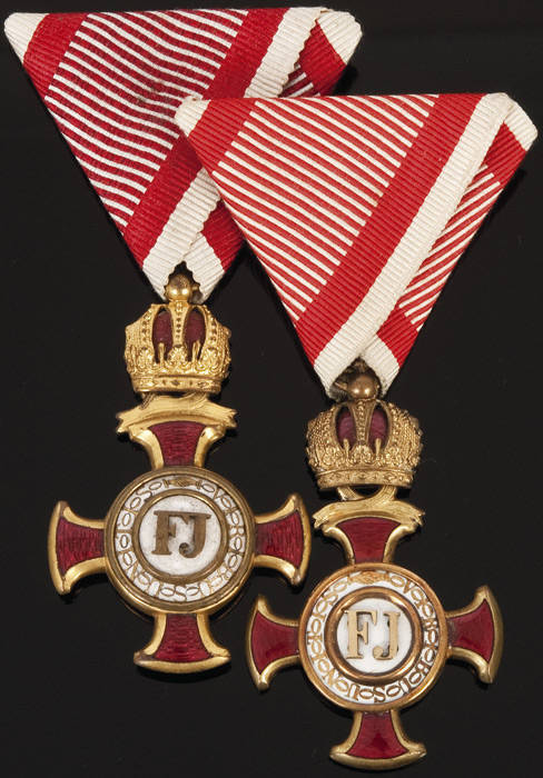 GOLDEN CROSS OF MERIT with Crown; Two versions of the Austro-Hungarian medal, enamel & gilt metal (red & white ribbons), both boxed. The order was presented for faithful service to the Emperor & services to public welfare over a long period of time. VG co